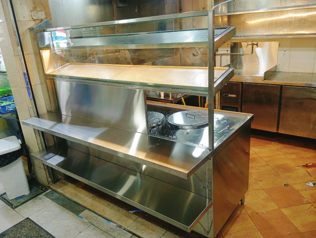 Stainless steel heated display station installed in a working commercial kitchen